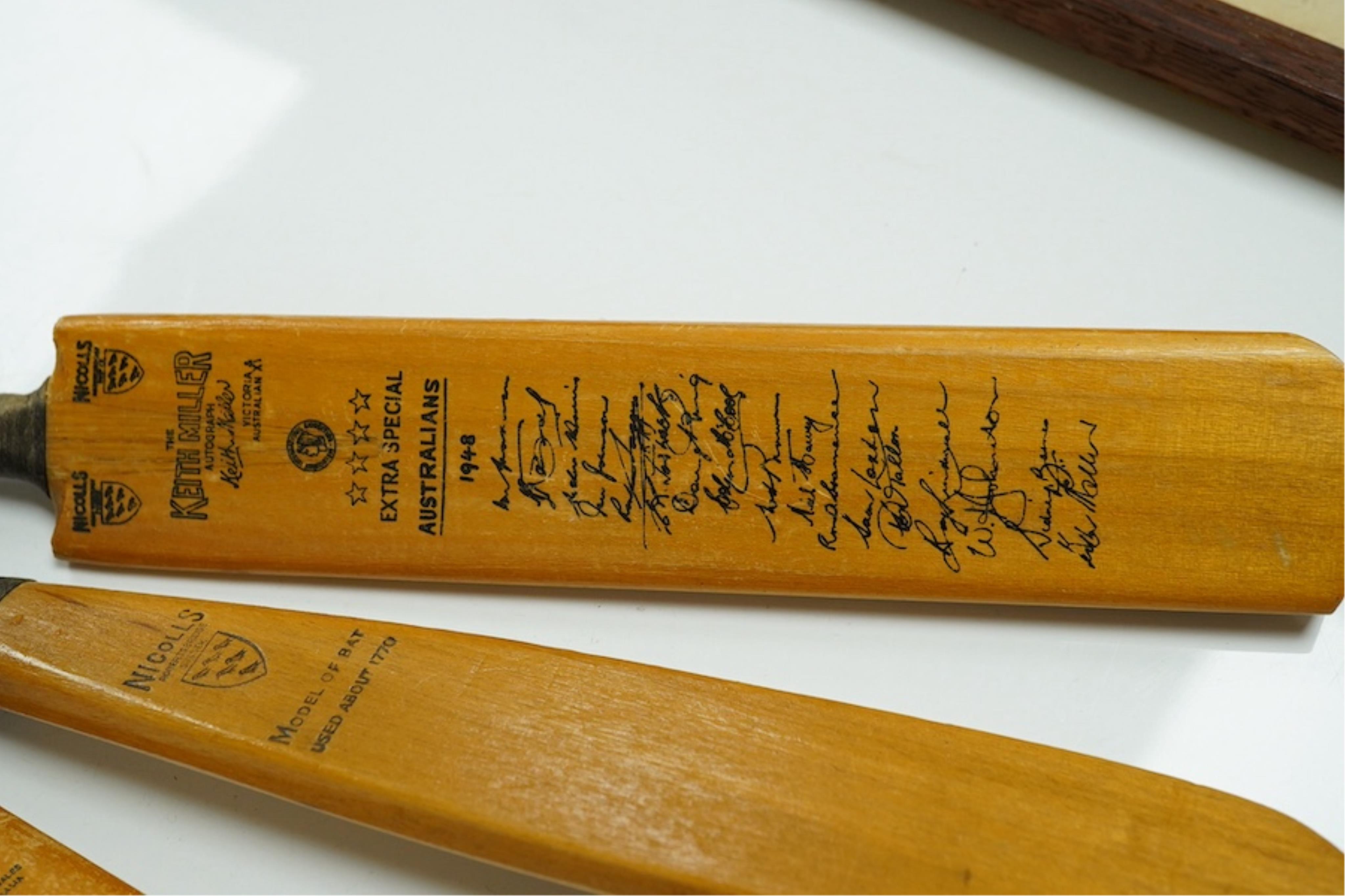 Four miniature model cricket bats, one signed, others printed. Condition - fair to good